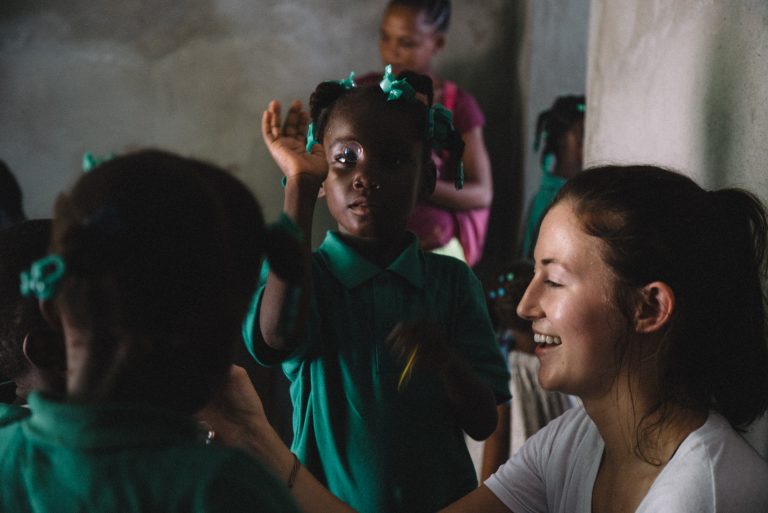 mission team member interacts with haitian children